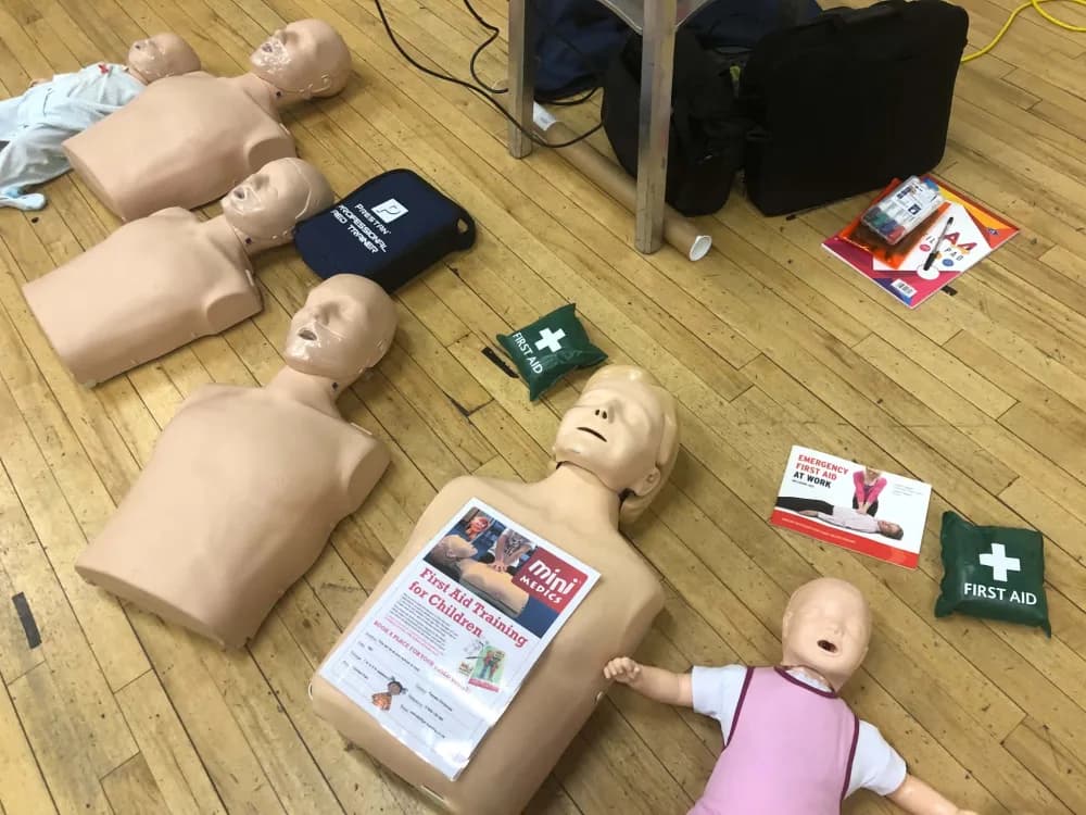 First aid training mannequins and equipment laid out ready for a session