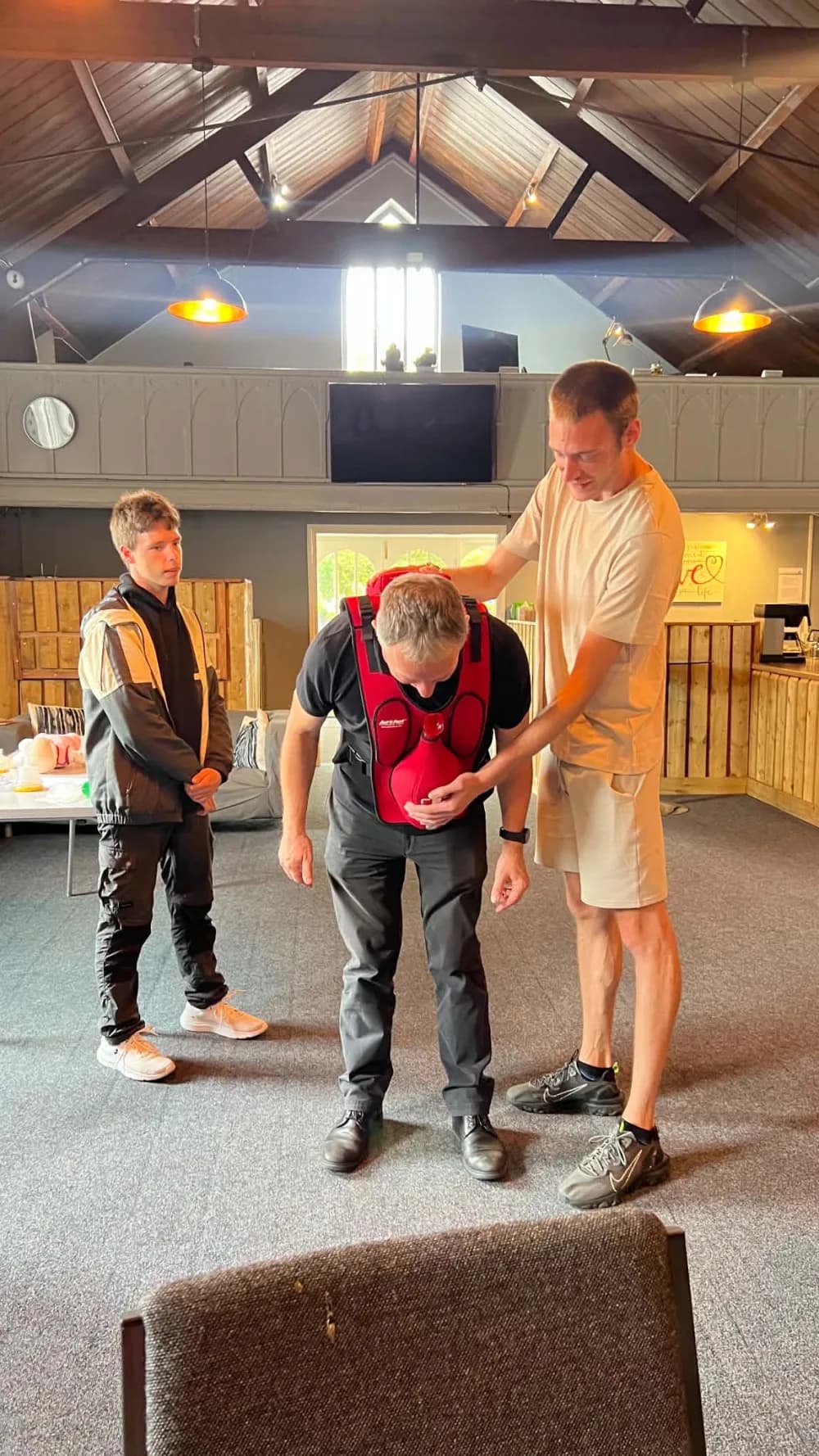 A participant practising with a CPR feedback vest during training